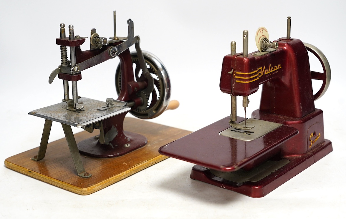 Two mid 20th century child’s sewing machines including a Vulcan Senior sewing machine in metallic red finish. Condition - fair